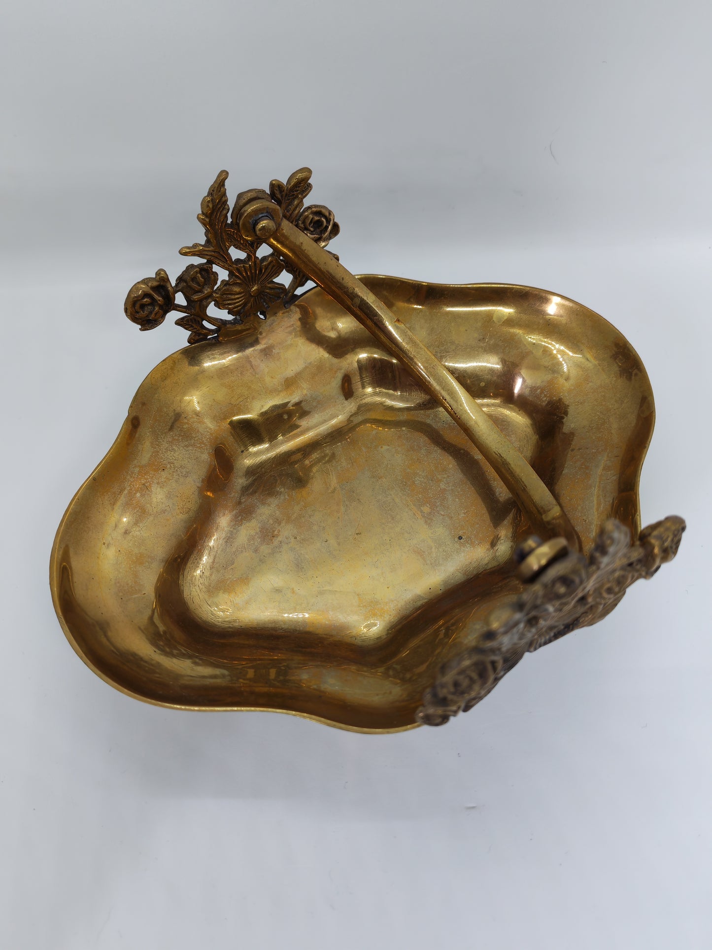 Small brass tray with floral decorations and a handle
