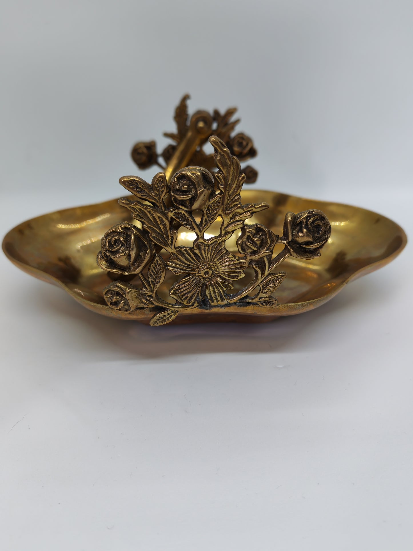Small brass tray with floral decorations and a handle