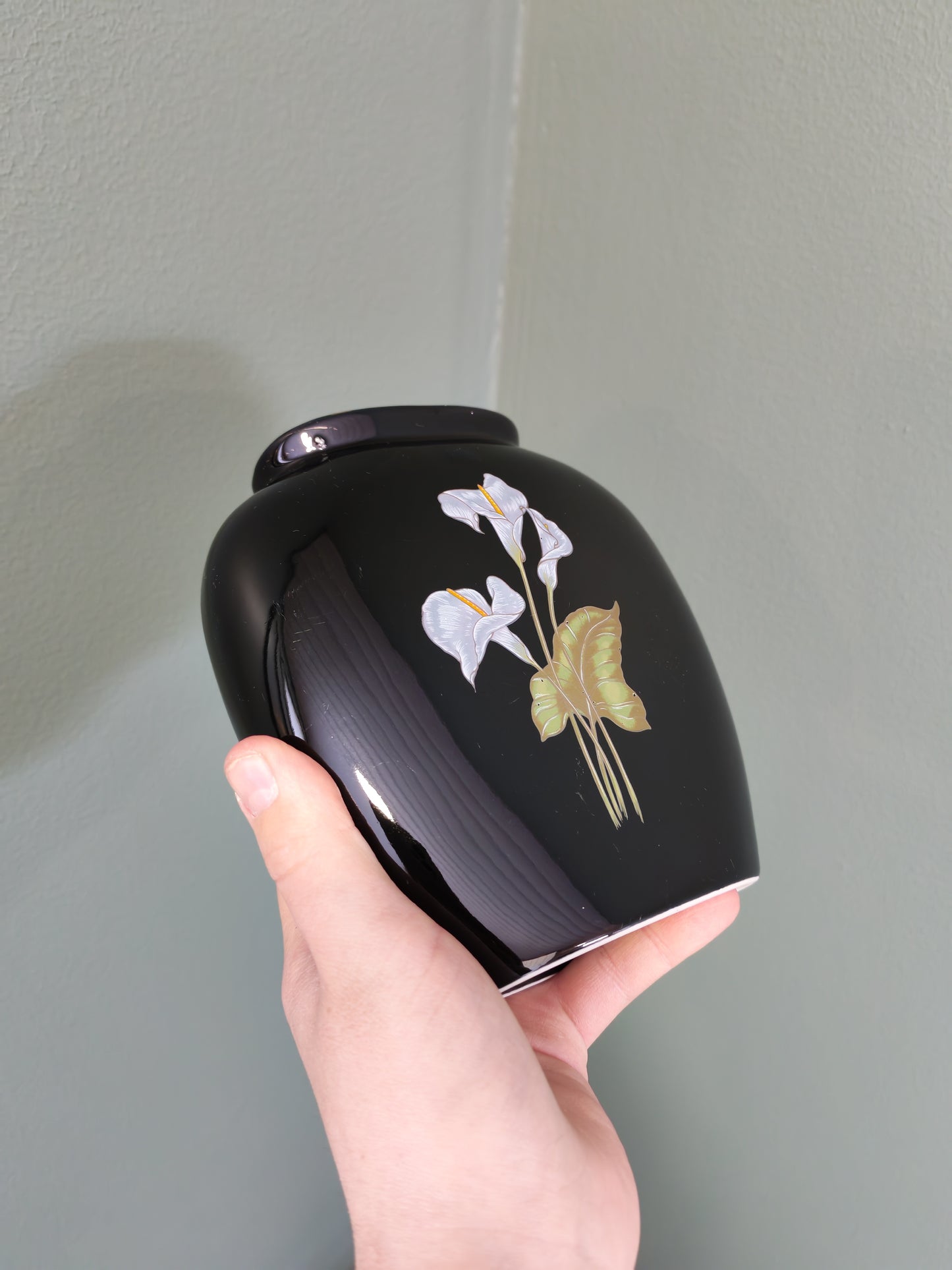 Black ceramic vase with a floral design