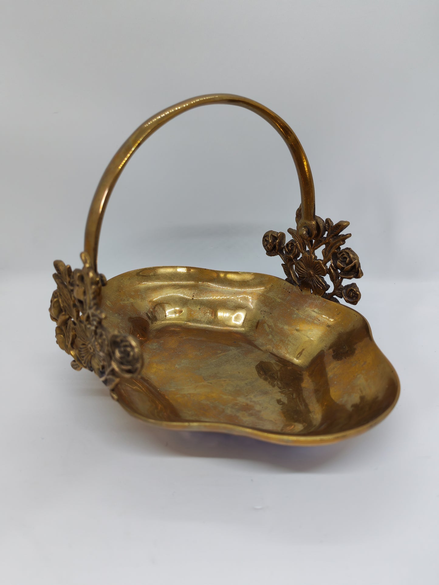 Small brass tray with floral decorations and a handle