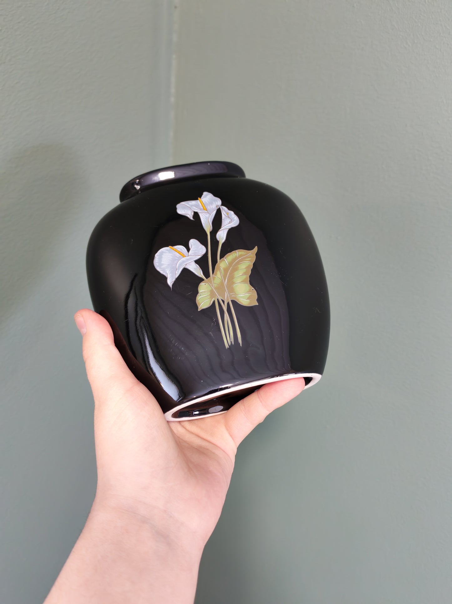 Black ceramic vase with a floral design