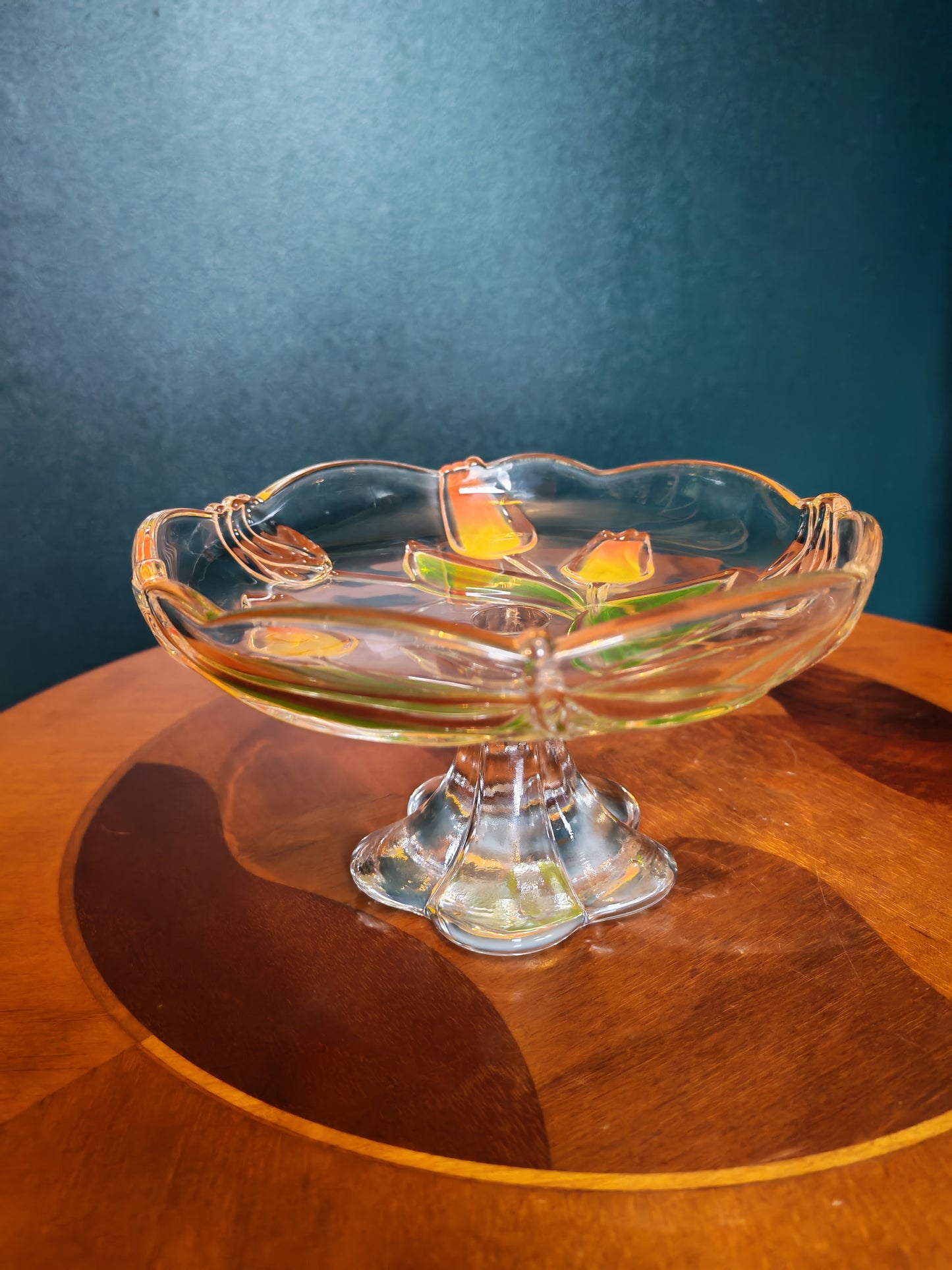 Glass serving platter with a stem and tulip motif