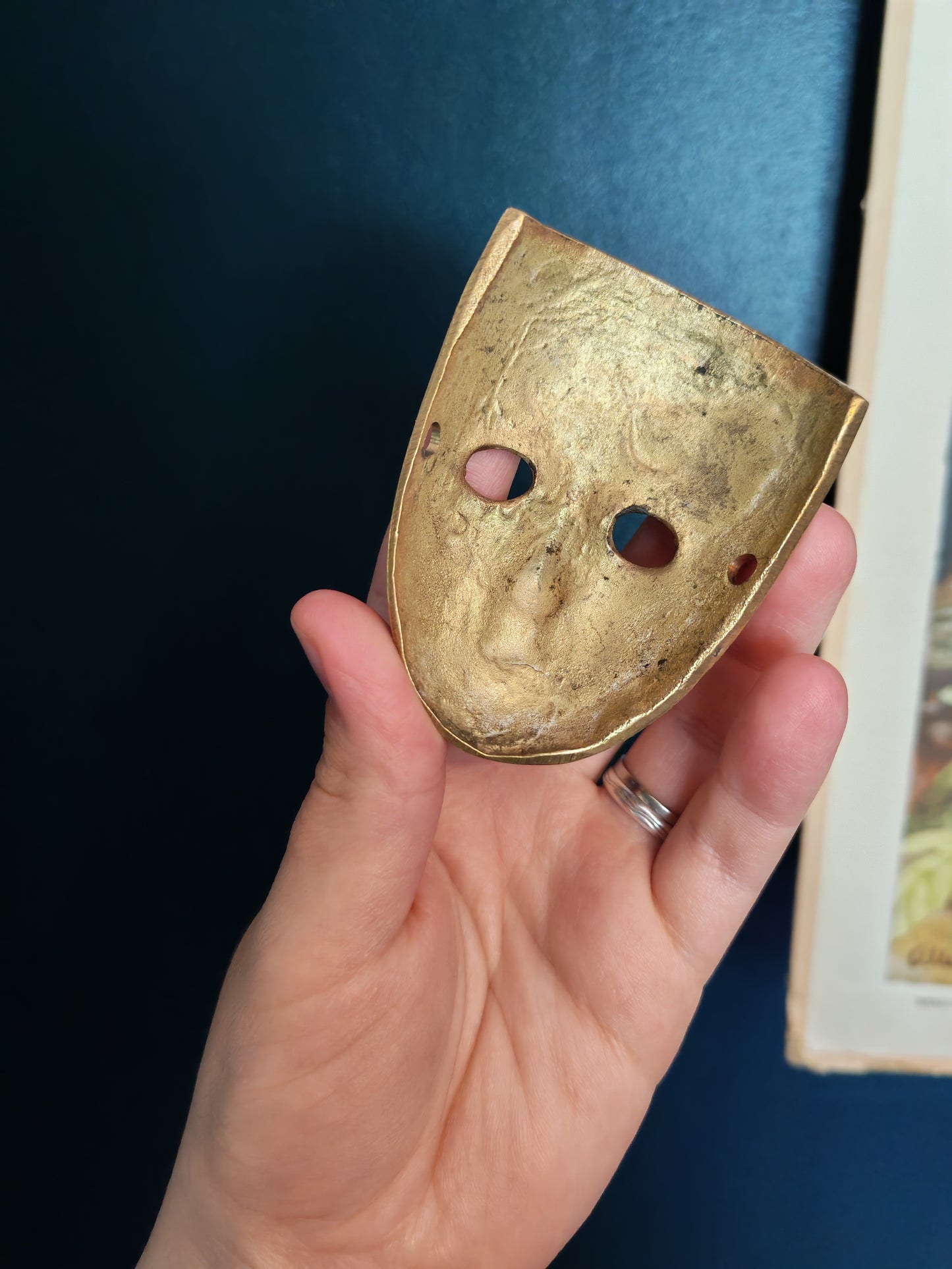 A small brass mask