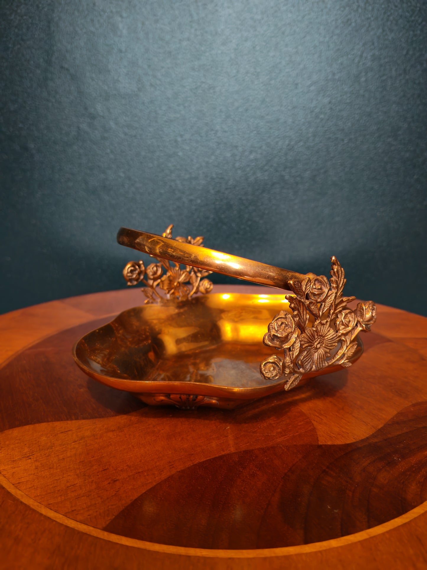 Small brass tray with floral decorations and a handle