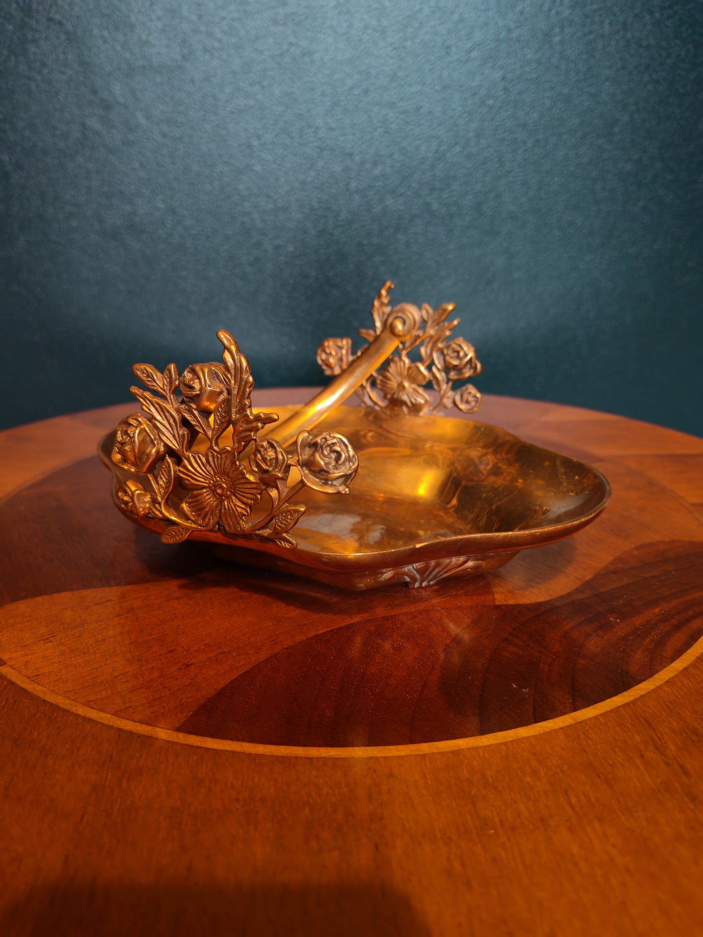 Small brass tray with floral decorations and a handle