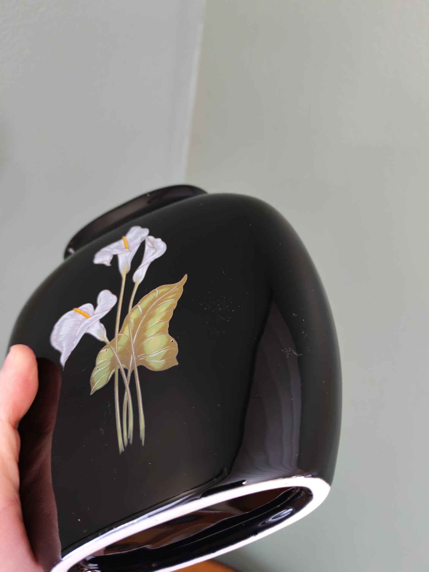 Black ceramic vase with a floral design