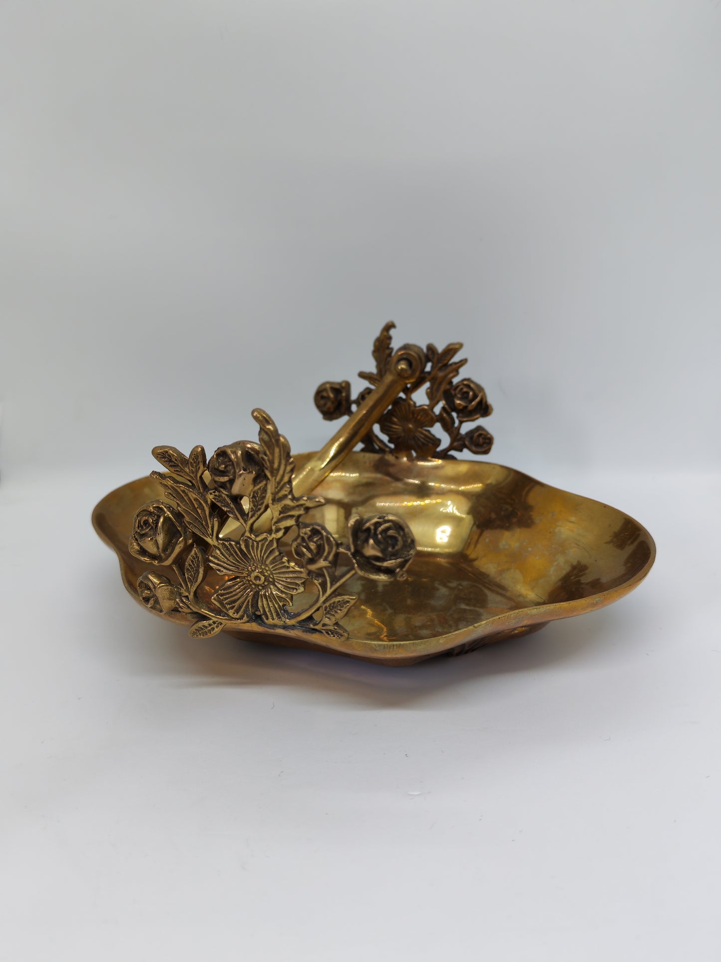 Small brass tray with floral decorations and a handle