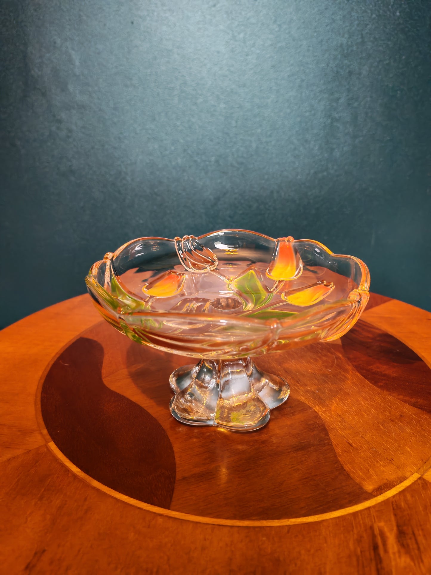 Glass serving platter with a stem and tulip motif