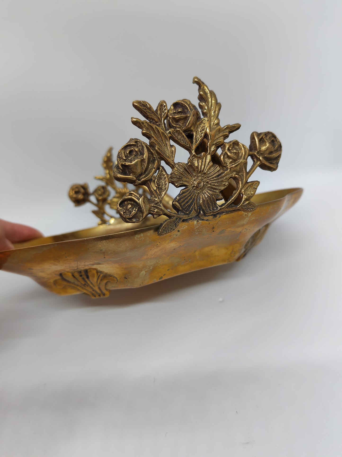 Small brass tray with floral decorations and a handle